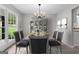 Dining room area with a chandelier, table set for six and a large hutch for storage at 2487 Highland Se Dr, Conyers, GA 30013