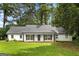The front exterior of this charming home boasts a well-manicured lawn and welcoming front porch at 2487 Highland Se Dr, Conyers, GA 30013