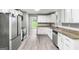 Bright kitchen features stainless appliances, granite countertops, and new gray wood-look flooring at 2487 Highland Se Dr, Conyers, GA 30013