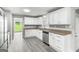 Modern kitchen featuring white cabinets, granite countertops, and stainless steel appliances at 2487 Highland Se Dr, Conyers, GA 30013
