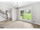 Bright living room featuring wood-look floors, gray walls and windows with a view of the front lawn at 2487 Highland Se Dr, Conyers, GA 30013
