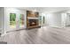 Open-concept living room showcasing a stone fireplace with french doors to a deck at 2487 Highland Se Dr, Conyers, GA 30013