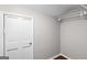Bright walk-in closet with wooden floors, white walls, door, and wire shelving, offering practical storage at 2487 Highland Se Dr, Conyers, GA 30013
