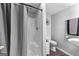 Basement bathroom featuring a walk-in shower with a gray shower curtain, toilet, and vanity sink at 435 Hampton Grn, Peachtree City, GA 30269