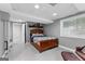 Basement bedroom with a wooden bed frame and a dark blue comforter set at 435 Hampton Grn, Peachtree City, GA 30269