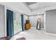 Finished basement area with french doors leading to the backyard and a wooden dresser at 435 Hampton Grn, Peachtree City, GA 30269