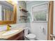 Half bathroom with an accent wall, unique shelves, a modern sink and faucet at 435 Hampton Grn, Peachtree City, GA 30269