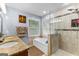Well-lit bathroom featuring a tub, step-in shower, tiled floors, and dual sinks with granite countertops at 435 Hampton Grn, Peachtree City, GA 30269