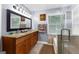 Bathroom featuring granite countertops, custom cabinetry, tiled floors, a step-in shower, and a jacuzzi tub at 435 Hampton Grn, Peachtree City, GA 30269
