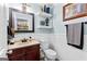Charming half bath featuring wainscoting, wood vanity, decorative mirror, and stylish fixtures at 435 Hampton Grn, Peachtree City, GA 30269