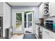 Bright kitchen featuring stainless steel appliances, wine storage, and a door leading to an outdoor deck at 435 Hampton Grn, Peachtree City, GA 30269
