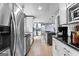 Spacious kitchen with white cabinets, stainless steel appliances, and hardwood floors throughout at 435 Hampton Grn, Peachtree City, GA 30269