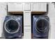 Laundry room featuring white cabinets above front-load washer and dryer at 435 Hampton Grn, Peachtree City, GA 30269