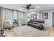 Inviting living room with hardwood floors, neutral paint, and large windows providing ample natural light at 435 Hampton Grn, Peachtree City, GA 30269