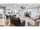 Open-concept living room with a kitchen island, fireplace, and hardwood floors, perfect for entertaining at 435 Hampton Grn, Peachtree City, GA 30269