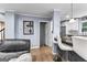 Comfortable living room and kitchen area with white cabinets, stainless appliances, and stylish barstool seating at 435 Hampton Grn, Peachtree City, GA 30269
