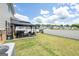 Large backyard with an outdoor seating area, fence, and lush green grass at 13568 Scenic Pkwy, Covington, GA 30014