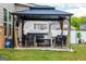 A backyard patio set with chairs under a gazebo near a house at 13568 Scenic Pkwy, Covington, GA 30014