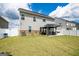 Well-kept backyard with lush grass, grey house siding, and gazebo with seating at 13568 Scenic Pkwy, Covington, GA 30014