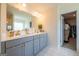 Bright bathroom features double vanity with modern fixtures and a walk-in closet at 13568 Scenic Pkwy, Covington, GA 30014