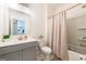 Clean bathroom with a modern vanity, grey cabinets, bright lighting, and a shower-tub combination at 13568 Scenic Pkwy, Covington, GA 30014