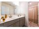Modern bathroom with double sinks, gray cabinetry, and elegant gold hardware at 13568 Scenic Pkwy, Covington, GA 30014
