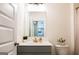 Bright bathroom featuring a modern vanity with gray cabinets, a quartz countertop, and brushed gold hardware at 13568 Scenic Pkwy, Covington, GA 30014