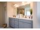 Modern bathroom features double sinks, gray cabinetry, and ample counter space at 13568 Scenic Pkwy, Covington, GA 30014