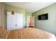 Bright bedroom boasts a view of the closet, TV, neutral tones, and modern lighting at 13568 Scenic Pkwy, Covington, GA 30014