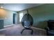Relaxing bedroom featuring a stylish hanging chair and comfortable seating area at 13568 Scenic Pkwy, Covington, GA 30014