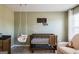 Charming Bedroom with crib, hanging chair, and warm, inviting decor at 13568 Scenic Pkwy, Covington, GA 30014