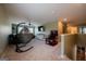 Spacious bonus room featuring a hanging chair, TV, plush furniture, and games at 13568 Scenic Pkwy, Covington, GA 30014