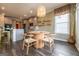 Open dining area featuring a round table, kitchen view, and decorative pendant light at 13568 Scenic Pkwy, Covington, GA 30014