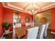 Dining room featuring a long table, six chairs, decorative wall art, and a bright chandelier at 13568 Scenic Pkwy, Covington, GA 30014