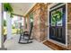 Welcoming front porch featuring classic rocking chairs and brickwork at 13568 Scenic Pkwy, Covington, GA 30014