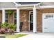 Inviting covered porch with rocking chairs and brick facade at 13568 Scenic Pkwy, Covington, GA 30014