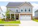 Two-story home features an attached two-car garage and well-maintained front yard at 13568 Scenic Pkwy, Covington, GA 30014