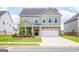 Charming two-story home with a manicured lawn and an attached two-car garage at 13568 Scenic Pkwy, Covington, GA 30014