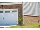 Attached garage with white door, brick facade, and house number 13568 at 13568 Scenic Pkwy, Covington, GA 30014