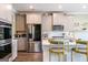 Kitchen featuring modern appliances, bar seating, and an open layout at 13568 Scenic Pkwy, Covington, GA 30014