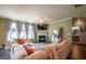 Bright living room featuring a fireplace, large windows, and a comfortable seating area at 13568 Scenic Pkwy, Covington, GA 30014