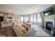 Comfortable living room with a large sofa, fireplace, and plenty of natural light at 13568 Scenic Pkwy, Covington, GA 30014