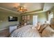 Bright bedroom features a ceiling fan, natural light, TV, and comfortable furniture at 13568 Scenic Pkwy, Covington, GA 30014
