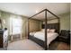 Bedroom with a four-post bed and natural light from a window at 13568 Scenic Pkwy, Covington, GA 30014
