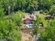Beautiful aerial view of the home, showcasing the pool, lush landscaping, and expansive outdoor space at 1572 Azalea Dr, Lawrenceville, GA 30043