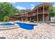 Outdoor patio, pool, and backyard view of a large brick home with multiple decks at 1572 Azalea Dr, Lawrenceville, GA 30043