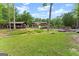 Lush backyard with a charming gazebo, manicured lawn, and mature trees providing shade and privacy at 1572 Azalea Dr, Lawrenceville, GA 30043