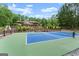 Sprawling backyard with a tennis court, lush landscaping, and mature trees at 1572 Azalea Dr, Lawrenceville, GA 30043