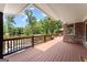 Backyard featuring inground pool, landscaping, deck, and lake at 1572 Azalea Dr, Lawrenceville, GA 30043