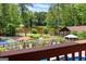 Overlooking a backyard oasis featuring a lake, pavilion, tennis court and in-ground pool for ultimate relaxation and recreation at 1572 Azalea Dr, Lawrenceville, GA 30043